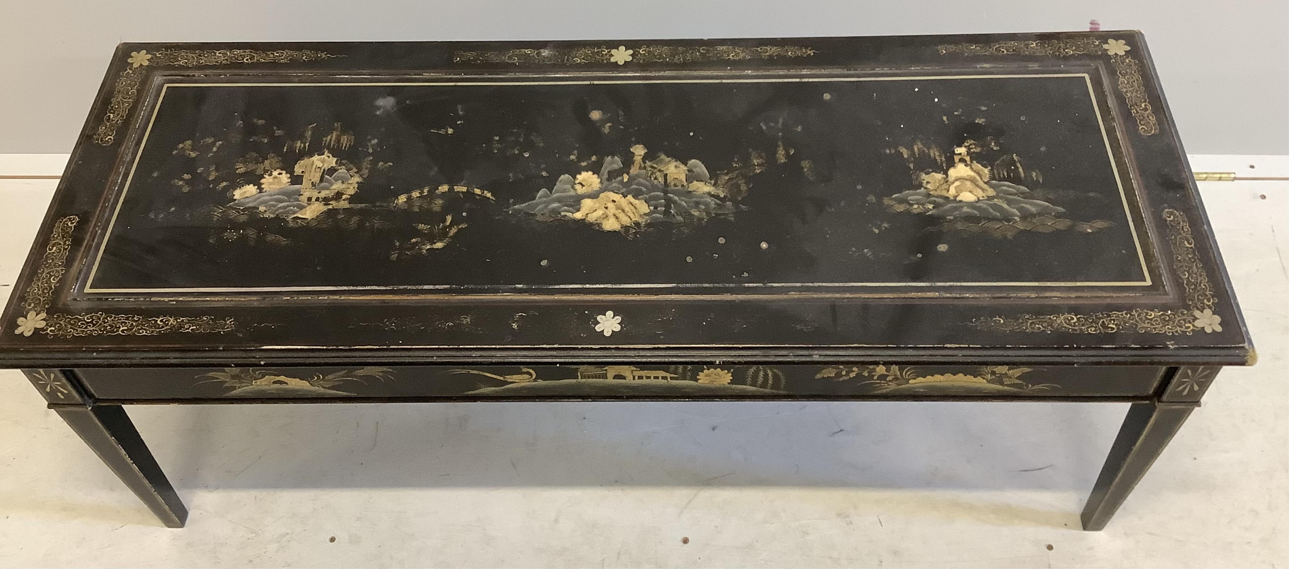 A rectangular black lacquered coffee table, width 120cm, depth 46cm, height 44cm. Condition - poor to fair